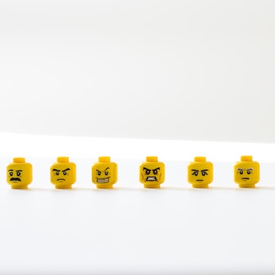 Lego figurine heads displaying different emotions.