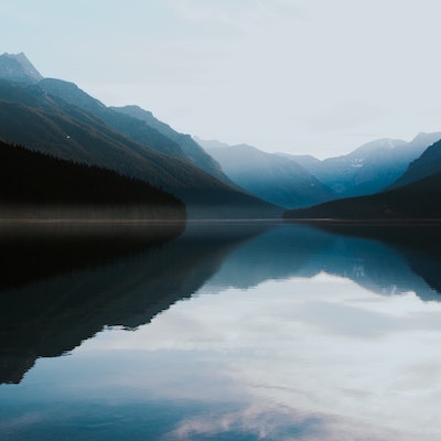 Reflection of misty Montana mountains in a lake.